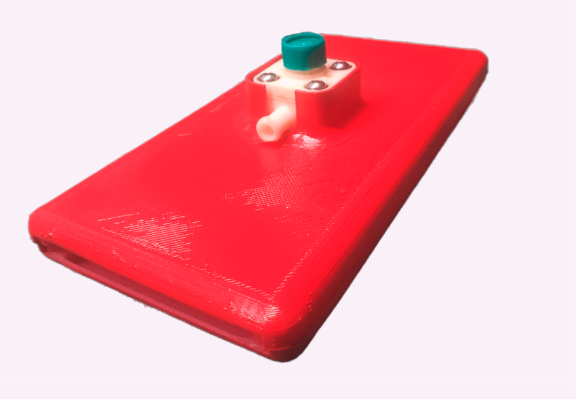 A red 3D-printed handheld slab with a small white fluid cell held by four screws and a teal cap, on a pale background